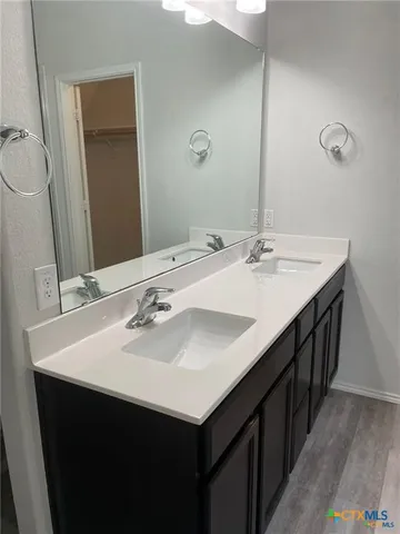 a kitchen with a sink and a mirror