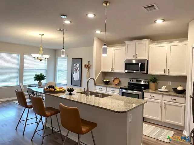 a kitchen with stainless steel appliances kitchen island granite countertop a sink and cabinets
