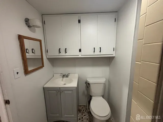 a white toilet sitting next to a bathroom sink