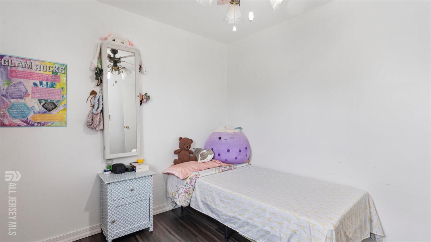 149 Ethel Street Menlo Park Terrace, NJ 08840 - Photo 15 of 26 a bedroom with a bed and chandelier