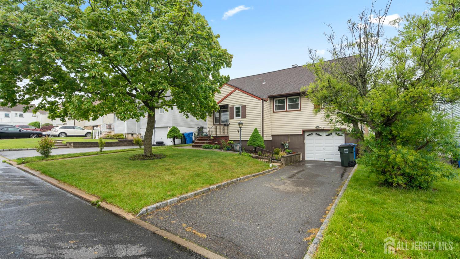 149 Ethel Street Menlo Park Terrace, NJ 08840 - Photo 2 of 26 a view of a white house next to a yard with big trees