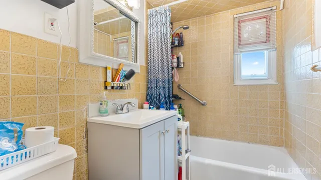 a bathroom with a sink mirror toilet and bathtub