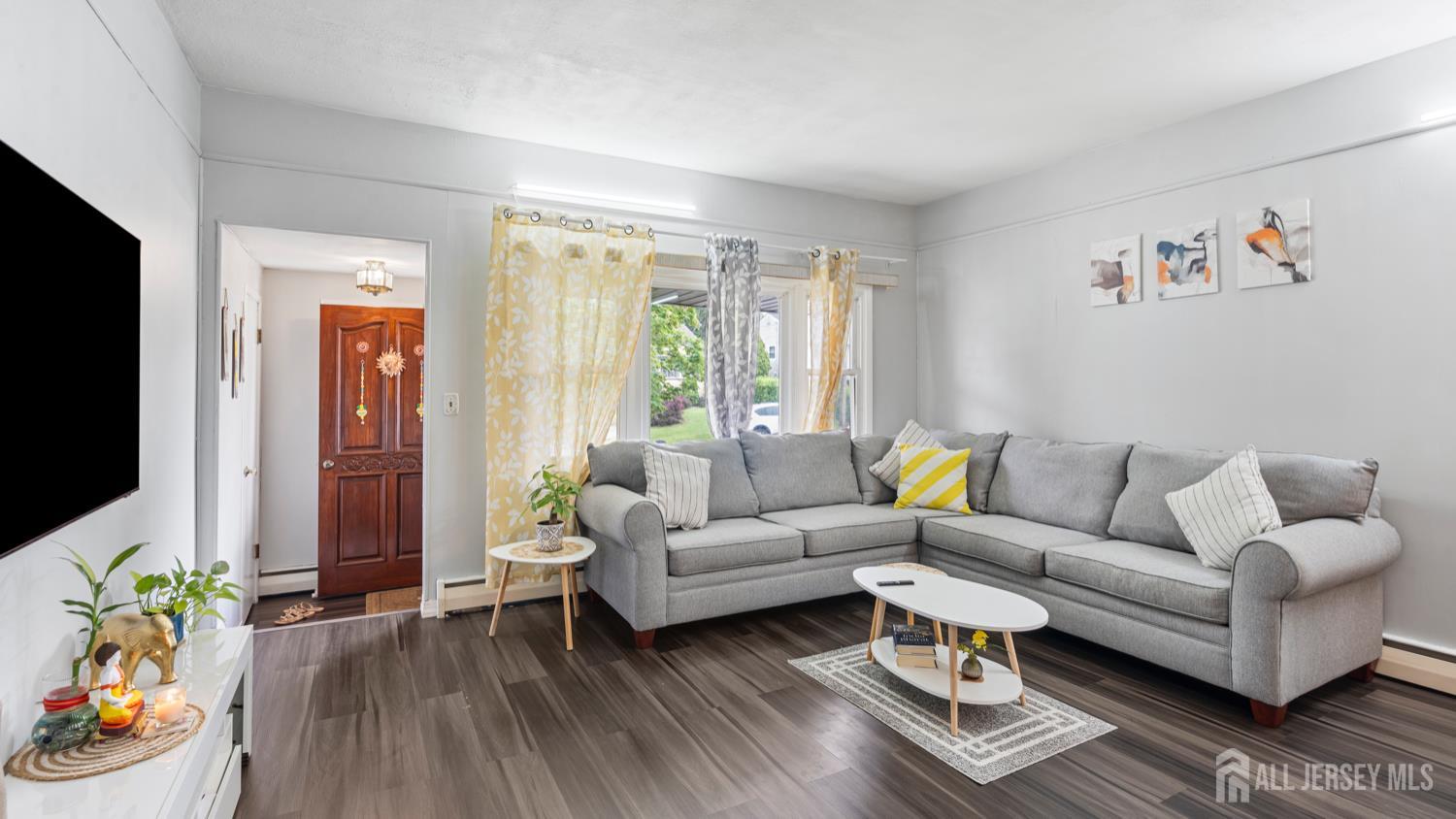 149 Ethel Street Menlo Park Terrace, NJ 08840 - Photo 5 of 26 a living room with furniture a flat screen tv and a window