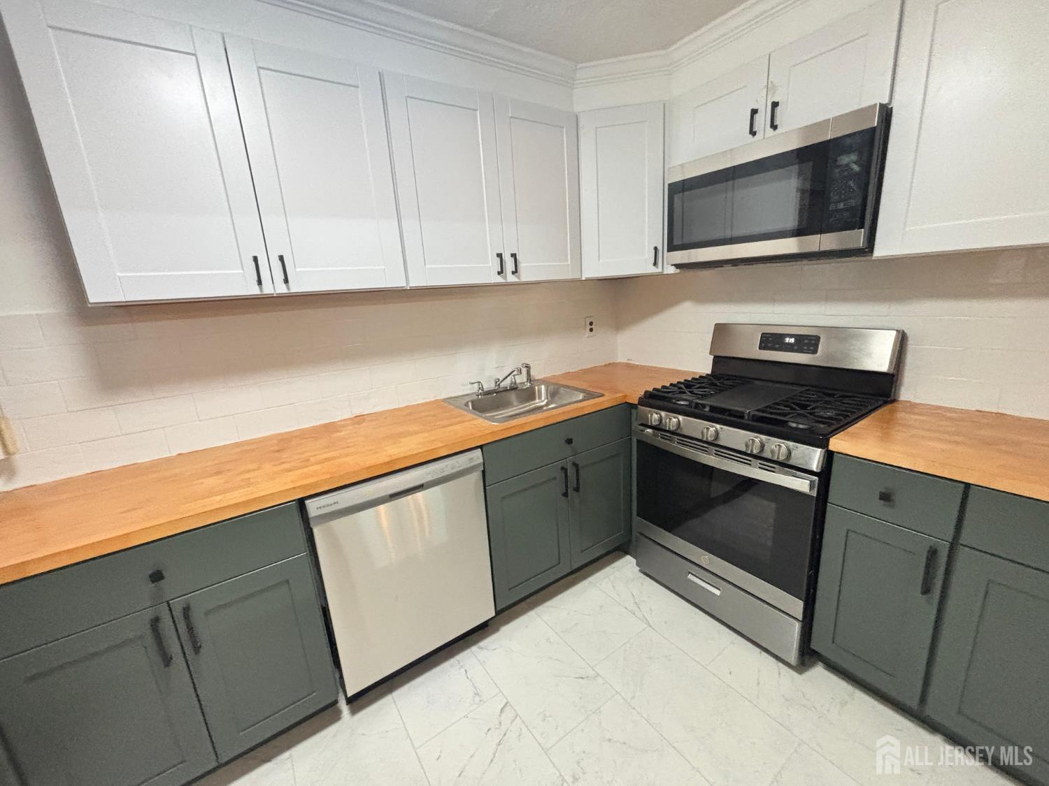 149 Ethel Street Menlo Park Terrace, NJ 08840 - Photo 7 of 26 a kitchen with granite countertop white cabinets and stainless steel appliances