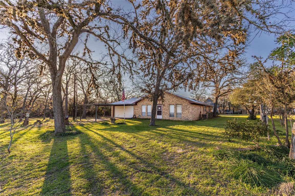 125 Forrest Lane Brenham, TX 77833 - Photo 4 of 13 a view of a house with a yard and sitting area