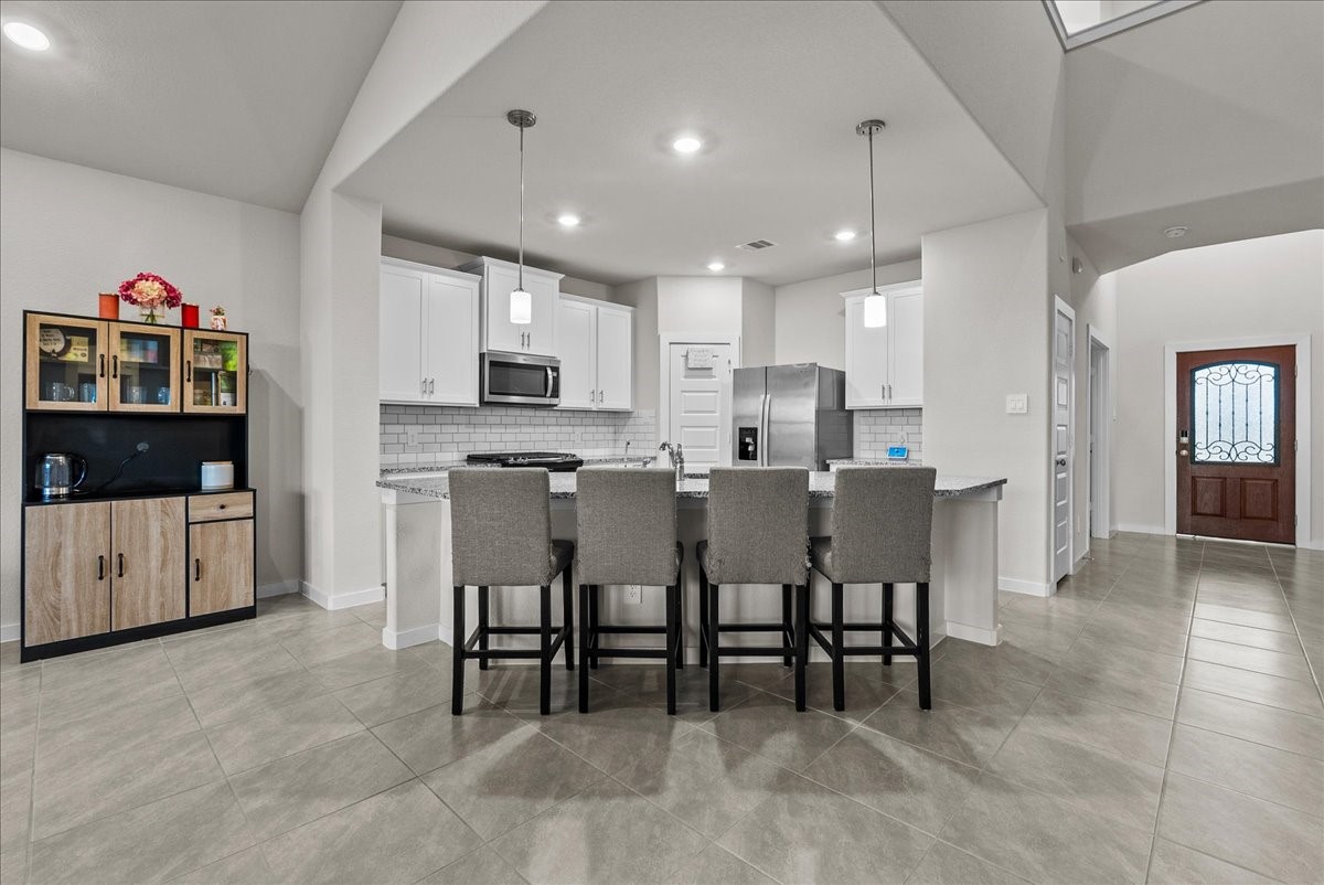 10831 Bodie Hls Drive Rosharon, TX 77583 - Photo 11 of 46 The kitchen’s corner layout maximizes space while maintaining flow for gatherings and daily use.