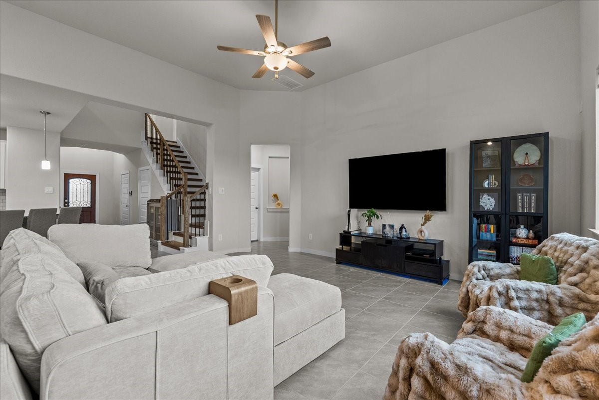 10831 Bodie Hls Drive Rosharon, TX 77583 - Photo 14 of 46 The living room is versatile in layout, filled with natural light, and provides easy access to a convenient half bathroom for guests.