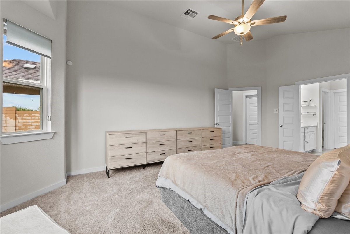 10831 Bodie Hls Drive Rosharon, TX 77583 - Photo 18 of 46 This large bedroom includes cozy carpet and a large ceiling fan for comfort.