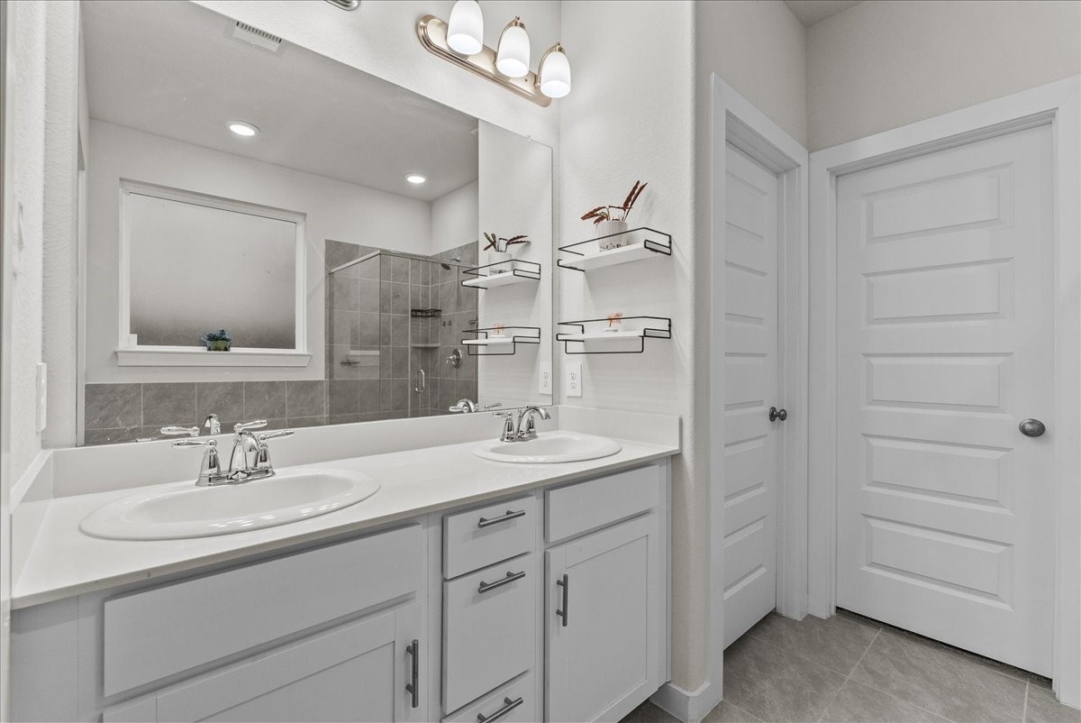 10831 Bodie Hls Drive Rosharon, TX 77583 - Photo 22 of 46 The en-suite also features a large walk-in closet, oversized mirror, and overhead lighting.