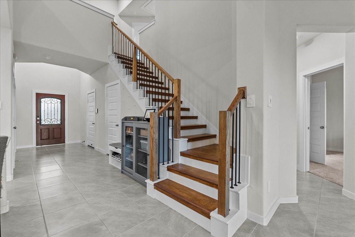 10831 Bodie Hls Drive Rosharon, TX 77583 - Photo 23 of 46 Wooden stairs lead upstairs, adding a sleek and durable design element.