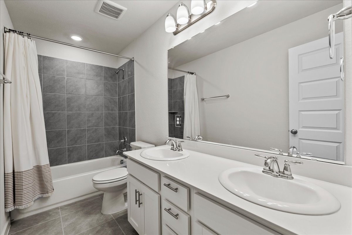 10831 Bodie Hls Drive Rosharon, TX 77583 - Photo 31 of 46 An additional upstairs bathroom offers dual sinks, a shower, and generous cabinet and drawer storage.