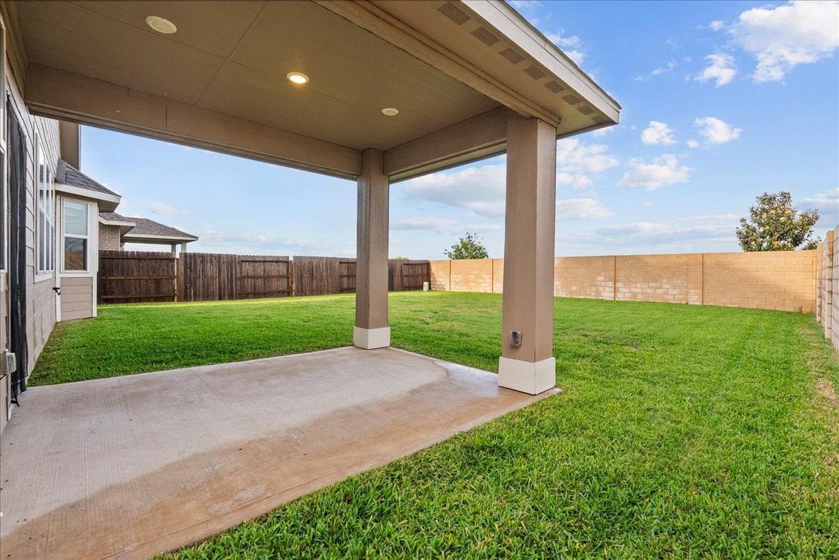 10831 Bodie Hls Drive Rosharon, TX 77583 - Photo 38 of 46 The patio includes exterior lighting and electrical outlets, ideal for entertaining or outdoor setups.