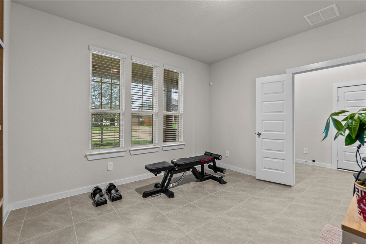 10831 Bodie Hls Drive Rosharon, TX 77583 - Photo 5 of 46 Expansive windows in the office provide natural light and a pleasant view of the front yard.