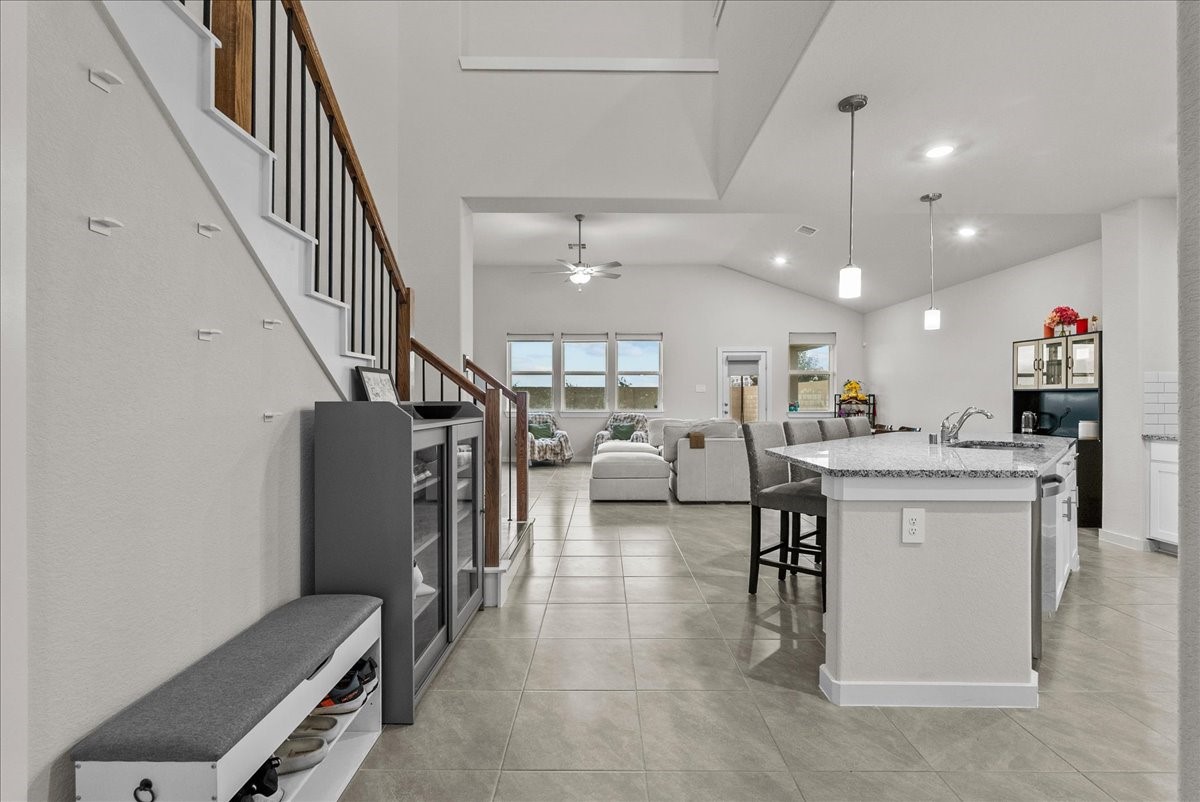 10831 Bodie Hls Drive Rosharon, TX 77583 - Photo 6 of 46 The entryway opens to a spacious, open-concept layout connecting the kitchen and living areas. The beautiful stairway also features wrought-iron spindles from top to bottom.