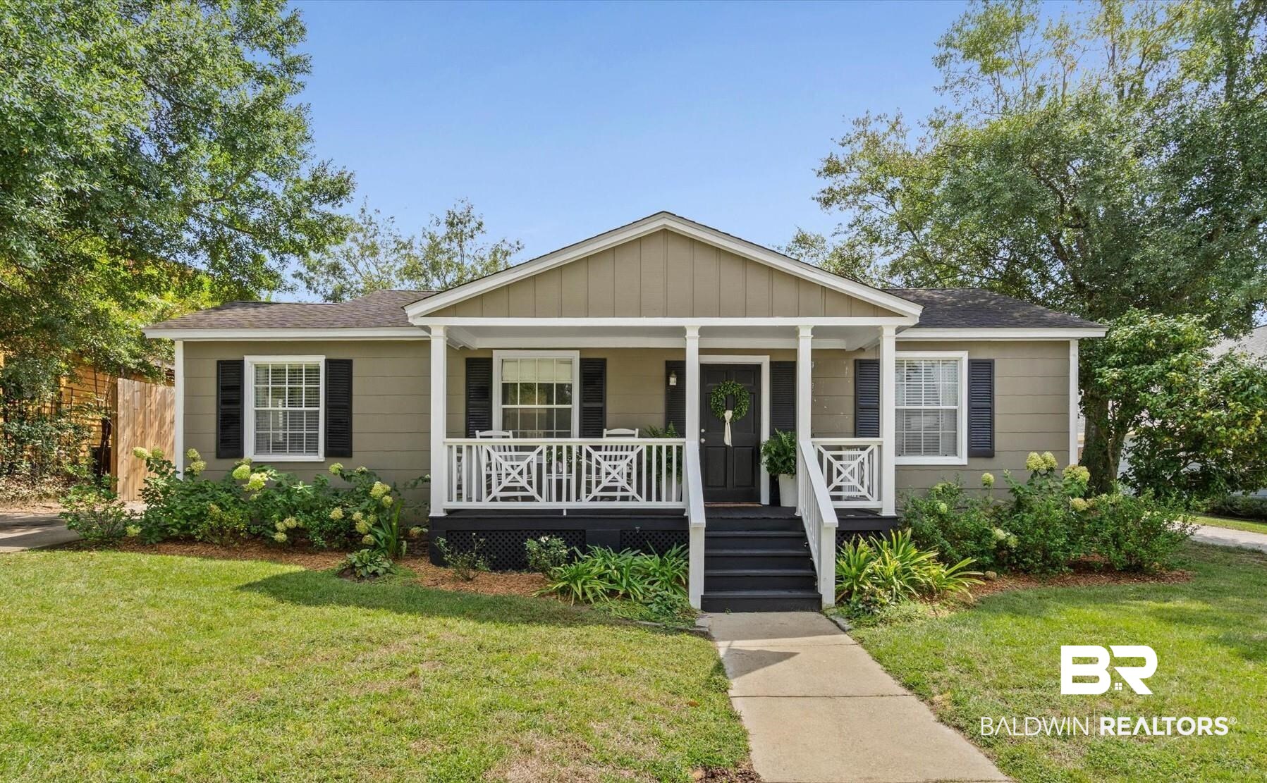 77 North Hathaway Road Mobile, AL 36608 - Photo 1 of 33 View of front of home featuring covered porch, a front yard, a shingled roof, and board and batten siding