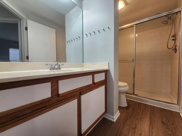 a view of an empty room with wooden floor