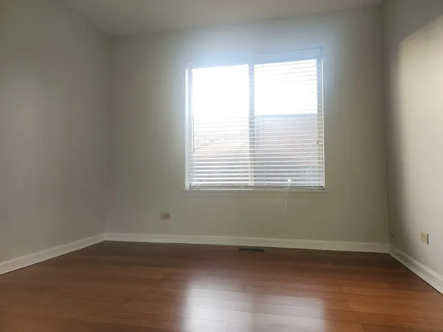 a balcony with wooden floor and fence