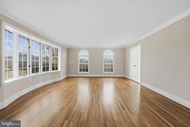 a large kitchen with cabinets wooden floor and stainless steel appliances