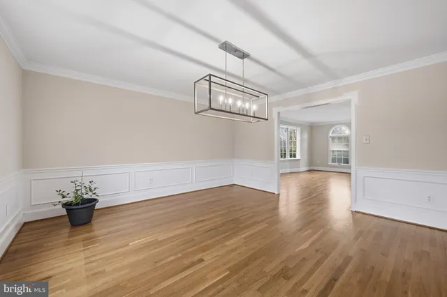 a view of a livingroom with furniture window and hardwood floor