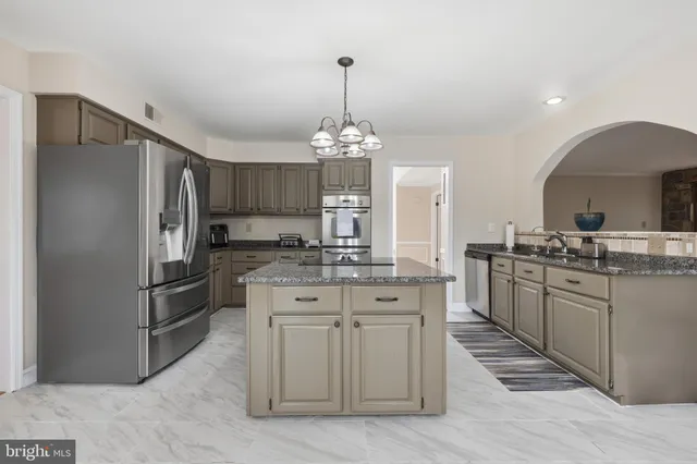 a view of a hallway with wooden floor and stairs