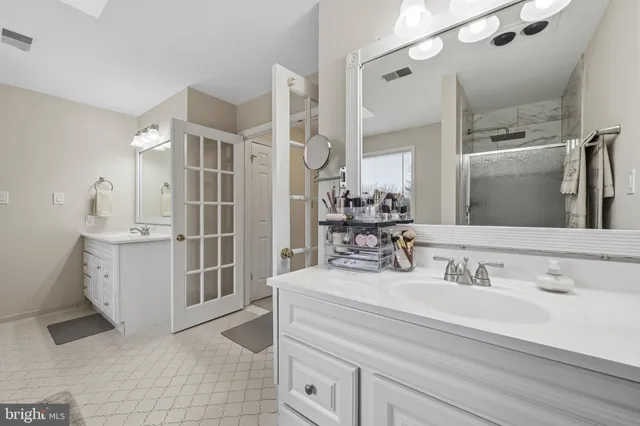 a bathroom with a shower sink and mirror