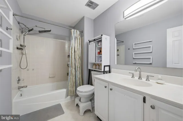 an aerial view of a house with a yard and lake view