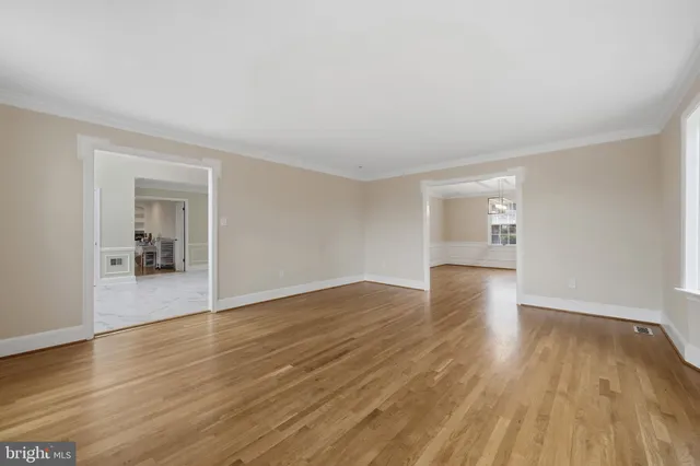 a kitchen with stainless steel appliances granite countertop a stove a refrigerator and a sink with wooden cabinets