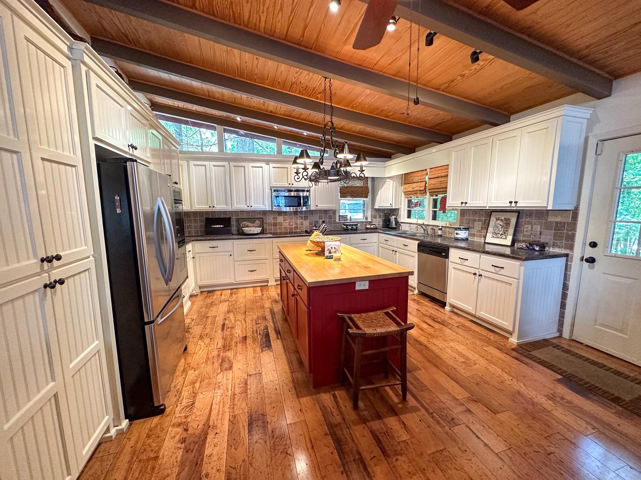 173 Cr 254 Road Iuka, MS 38852 - Photo 13 of 32 a kitchen with wooden floors and stainless steel appliances