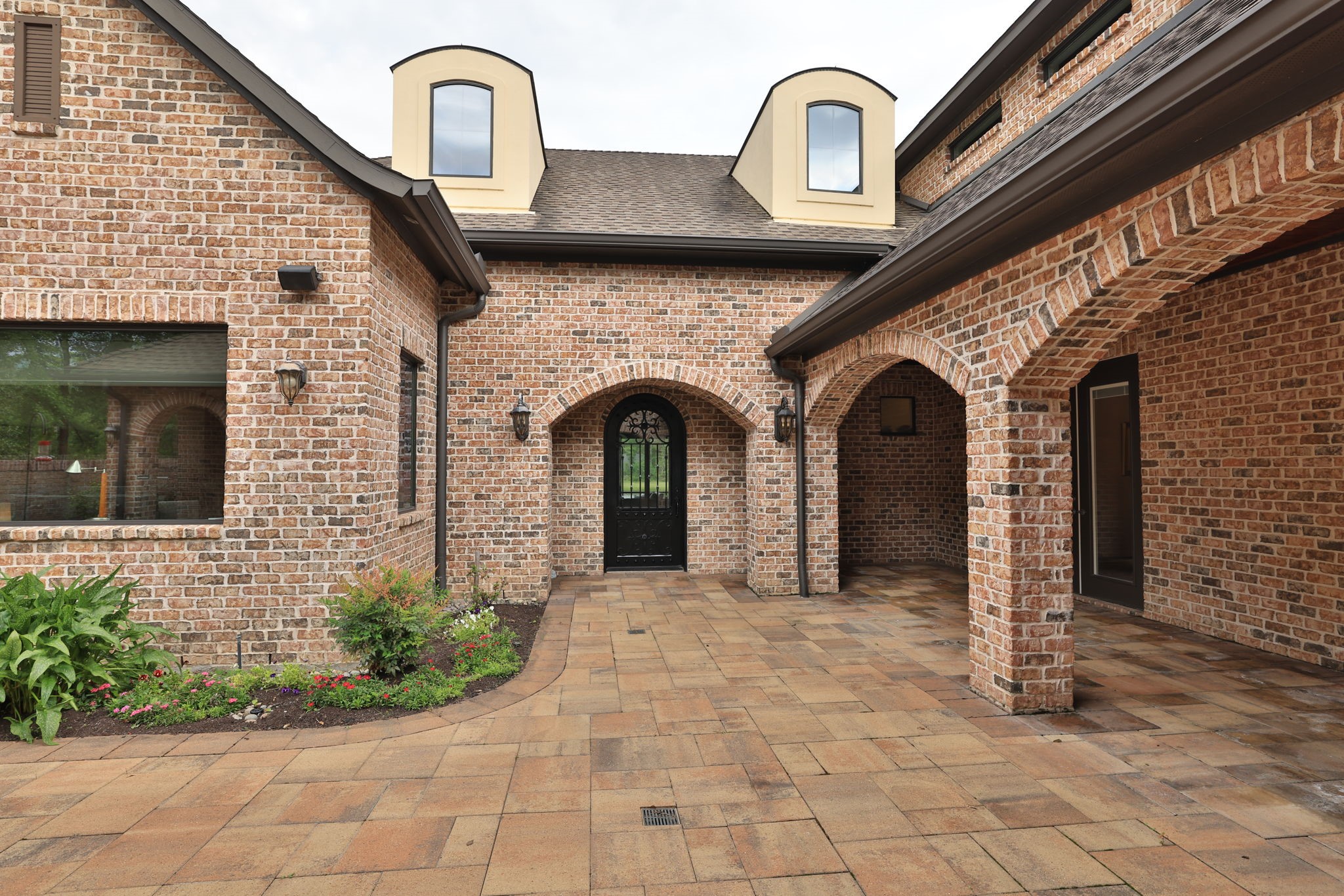 6918 Comanche Bend Montgomery, TX 77316 - Photo 12 of 50 Looking ahead is the entry into the main home. The picture window to the left overlooks your private office space with beautiful courtyard views, while the doors to the right lead into the formal dining area. This inviting courtyard creates the perfect extension of the home, allowing wonderful overflow space for casual dining, entertaining, and gathering with family and guests.