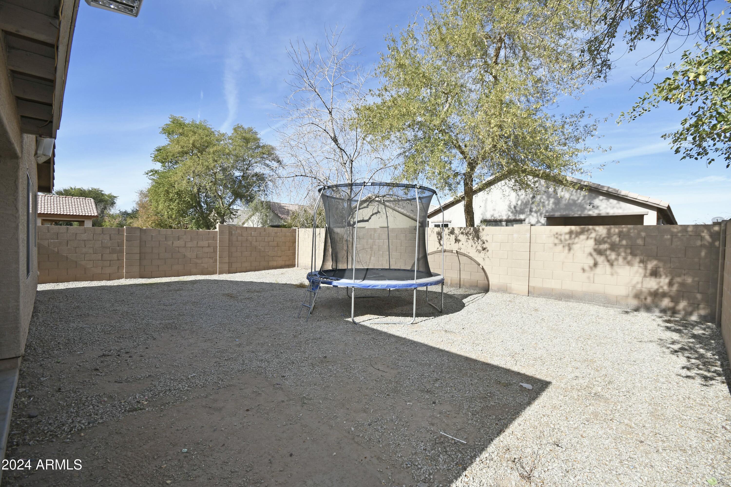 2414 West Gaby Road Phoenix, AZ 85041 - Photo 16 of 17 a backyard of a house with table and chairs