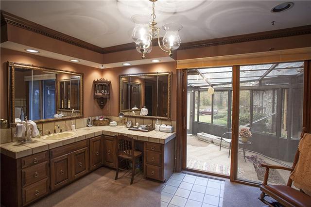 6040 South Mt Juliet Road Hermitage, TN 37076 - Photo 14 of 17 a bathroom with a sink double vanity and a glass door shower