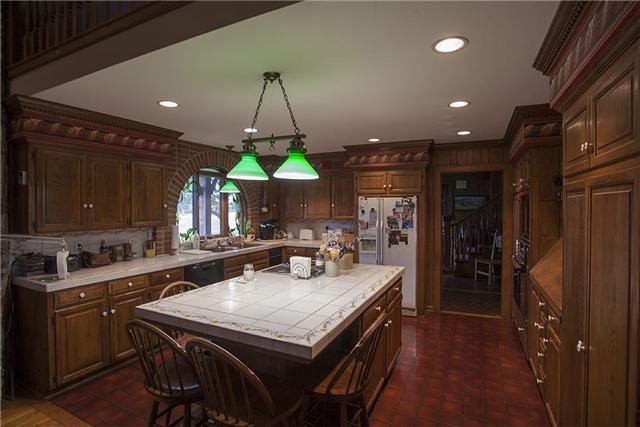 6040 South Mt Juliet Road Hermitage, TN 37076 - Photo 2 of 17 a kitchen with a table chairs sink and cabinets