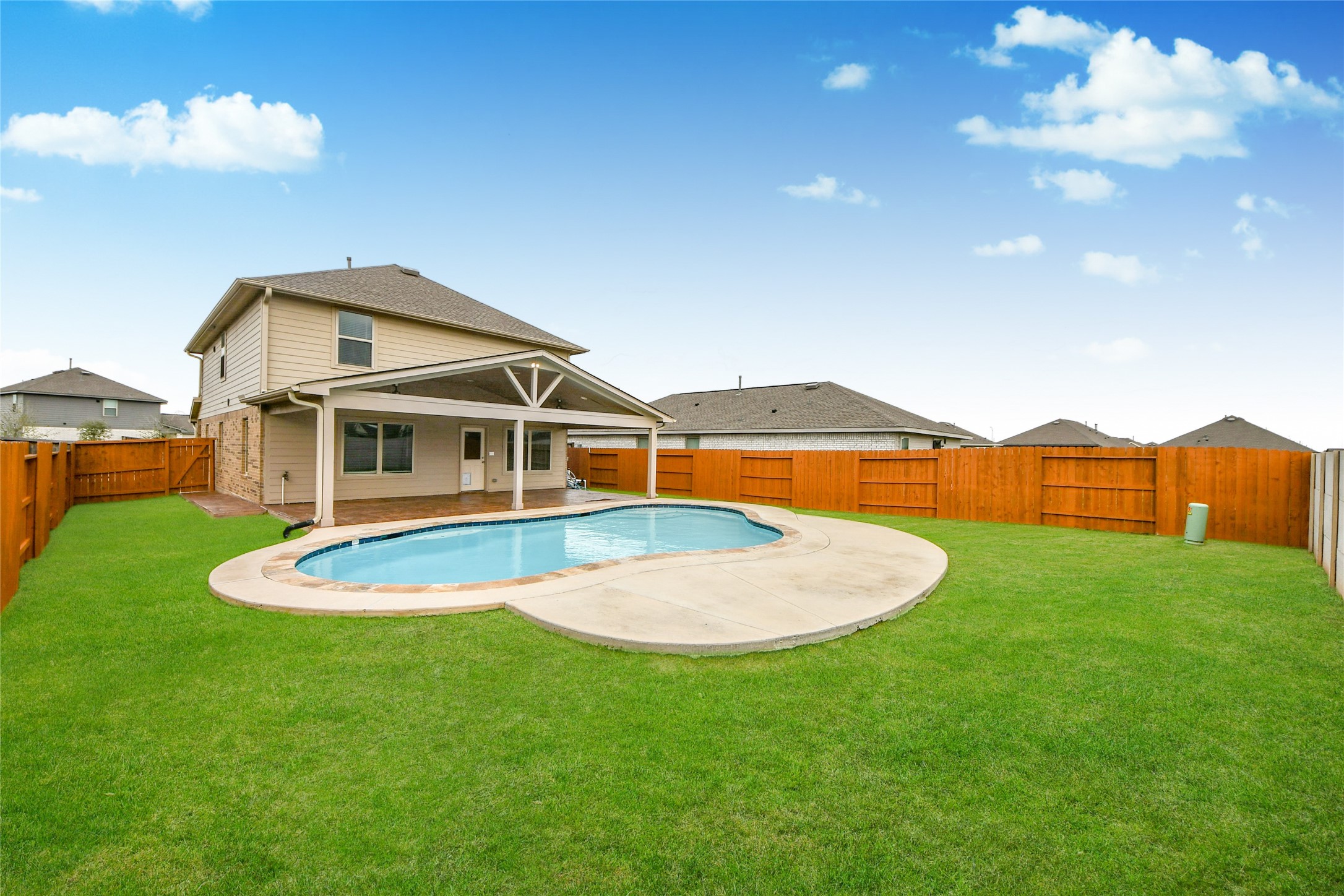 5011 Stratton Lane Rosharon, TX 77583 - Photo 32 of 38 Spacious patio area surrounding the pool for outdoor seating and gatherings.