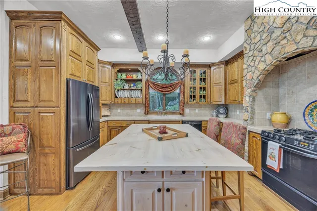 a view of a dining room with furniture and chandelier