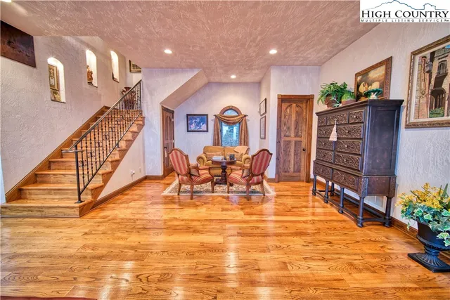 a bedroom with furniture and a large window