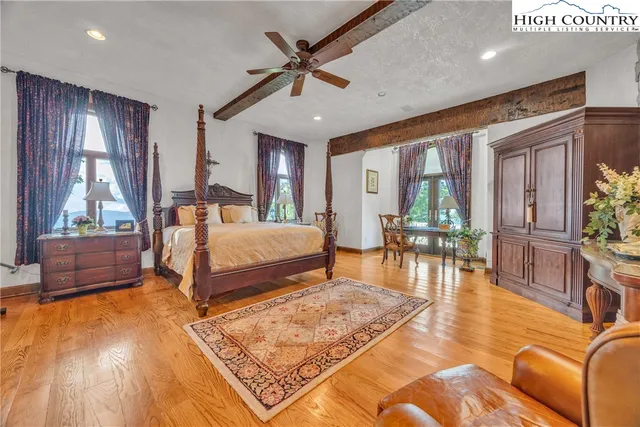 a bedroom with two beds and painting on the wall
