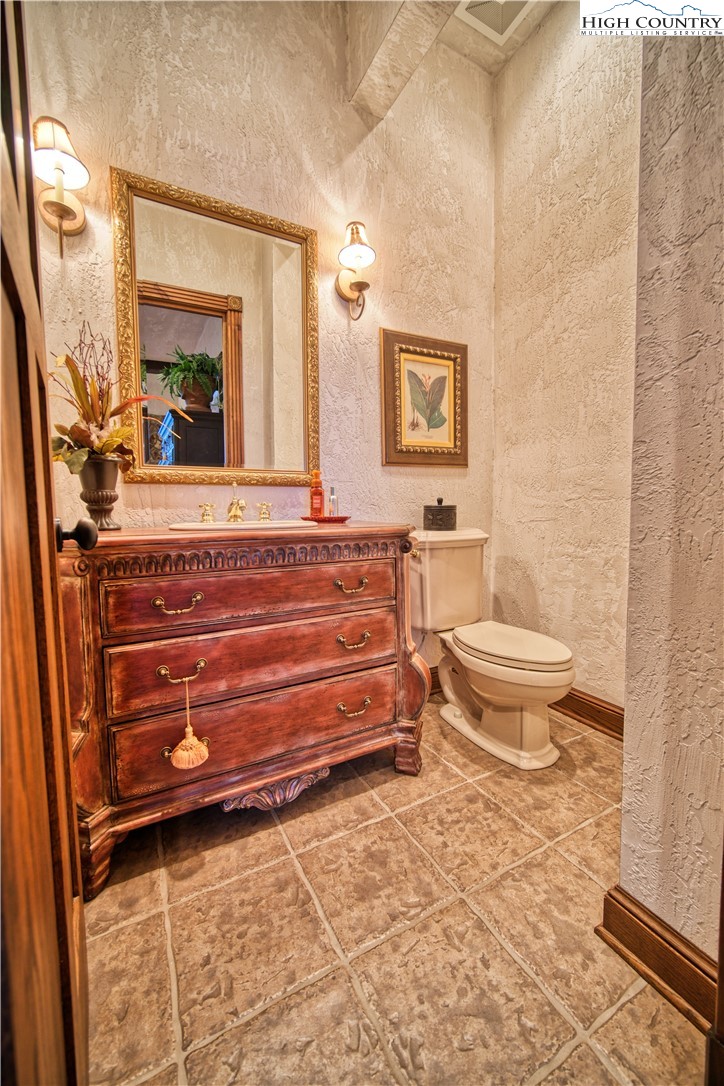 530 Howards Knob Road Boone, NC 28607 - Photo 20 of 49 a bathroom with a toilet a sink and mirror