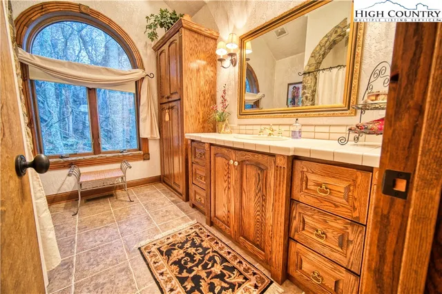 a bathroom with a sink a mirror and a shower