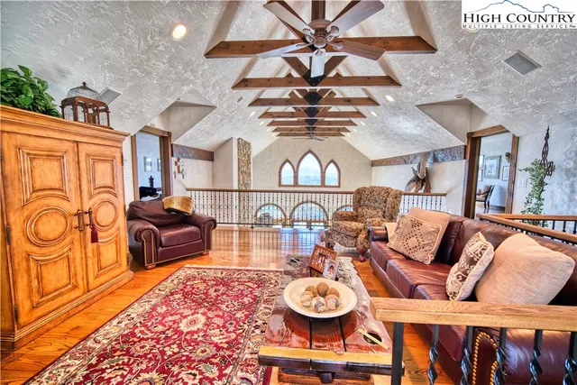 a living room with fireplace furniture and a rug
