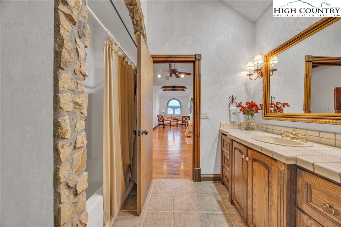 530 Howards Knob Road Boone, NC 28607 - Photo 35 of 49 a en suite bathroom with a granite countertop sink and a mirror