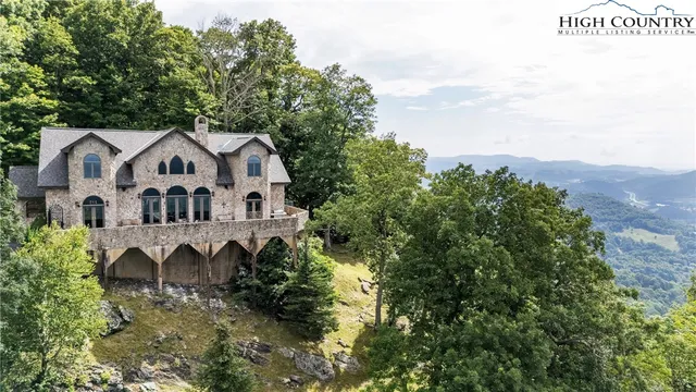 a view of a houses with a lush green hillside