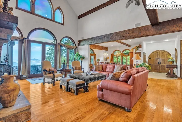 a living room with fireplace furniture and a large window
