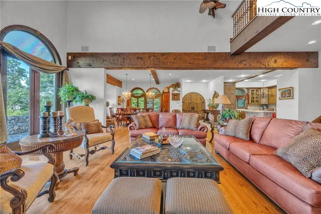 a living room with furniture fireplace and a large window