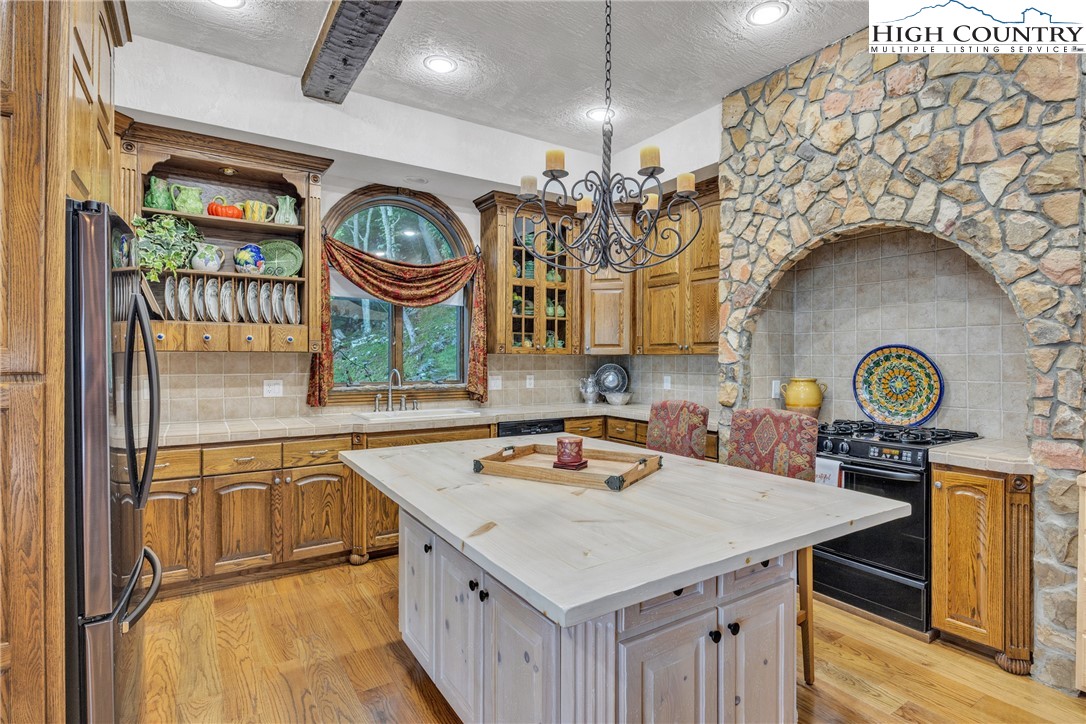 530 Howards Knob Road Boone, NC 28607 - Photo 7 of 49 a kitchen with a sink a stove cabinets and a clock