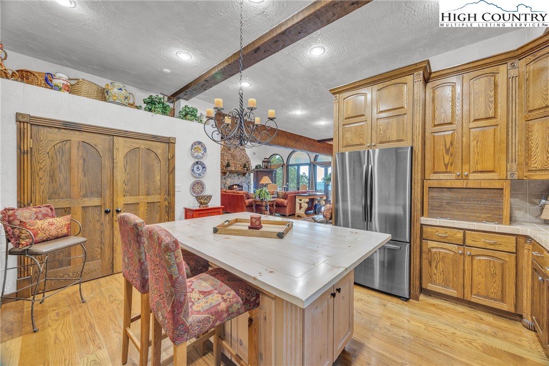 530 Howards Knob Road Boone, NC 28607 - Photo 8 of 49 a kitchen with stainless steel appliances granite countertop a table chairs and a refrigerator