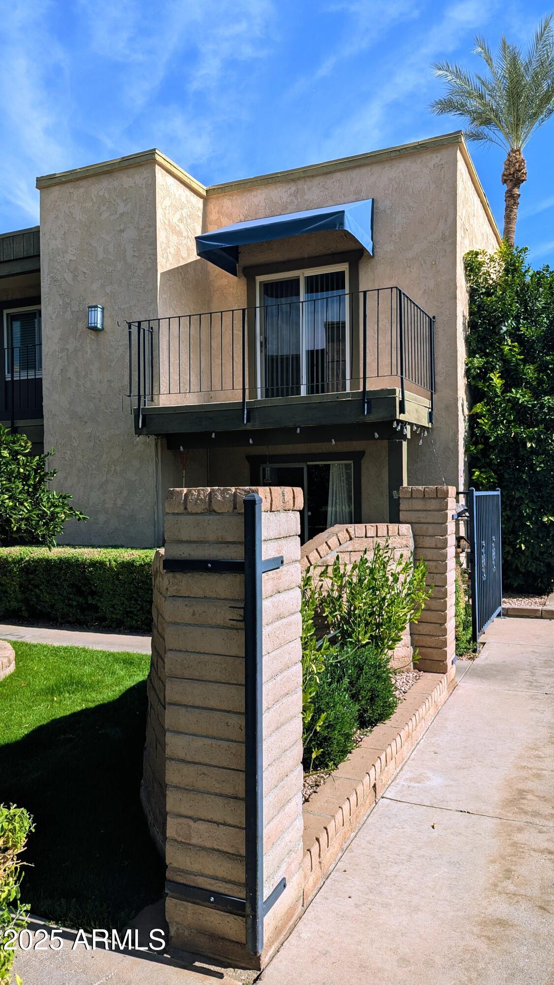 2228 East Campbell Avenue, Unit 234 Phoenix, AZ 85016 - Photo 1 of 18 a front view of a house with a garden