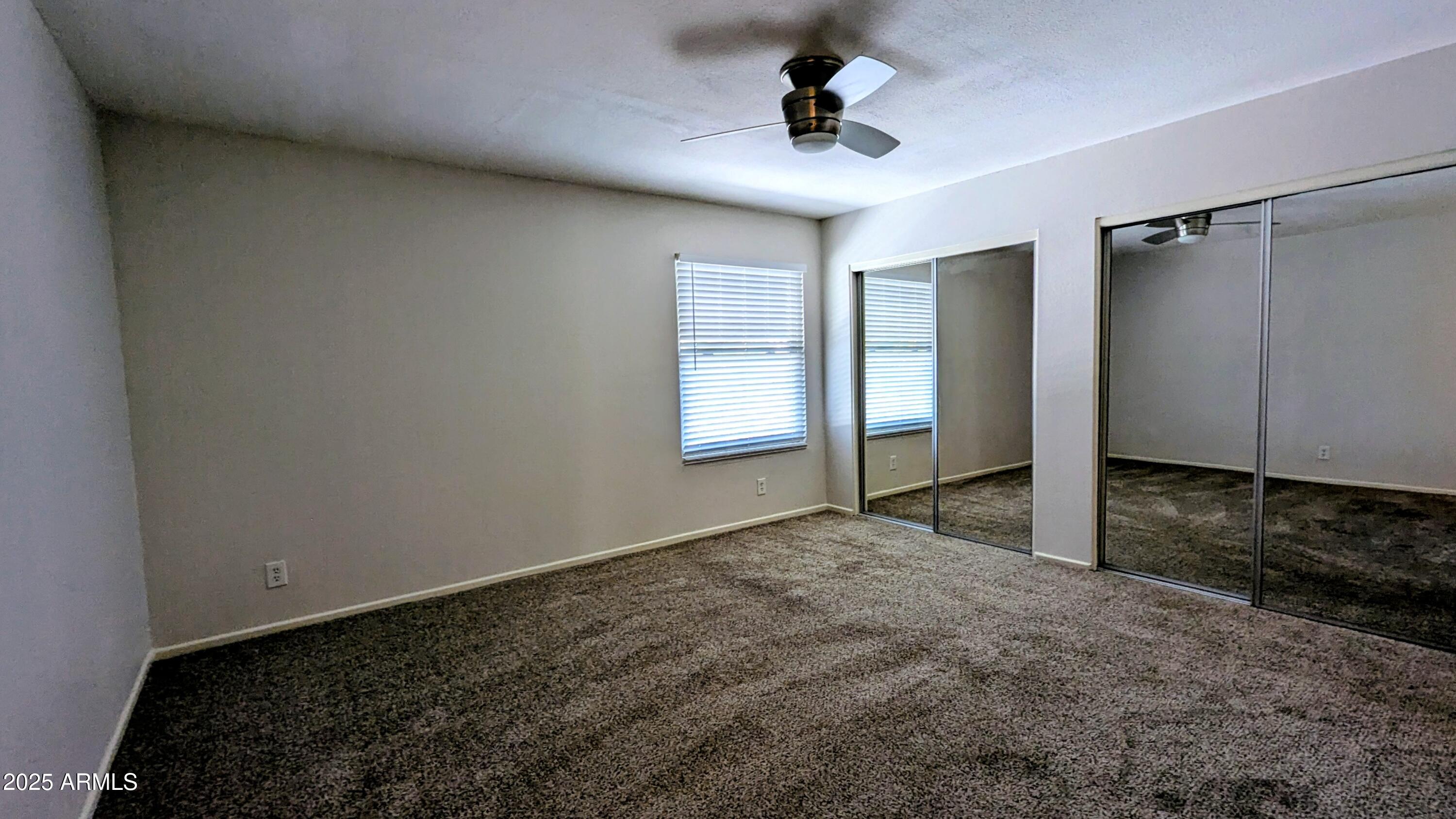 2228 East Campbell Avenue, Unit 234 Phoenix, AZ 85016 - Photo 15 of 18 a view of empty room with wooden floor and window
