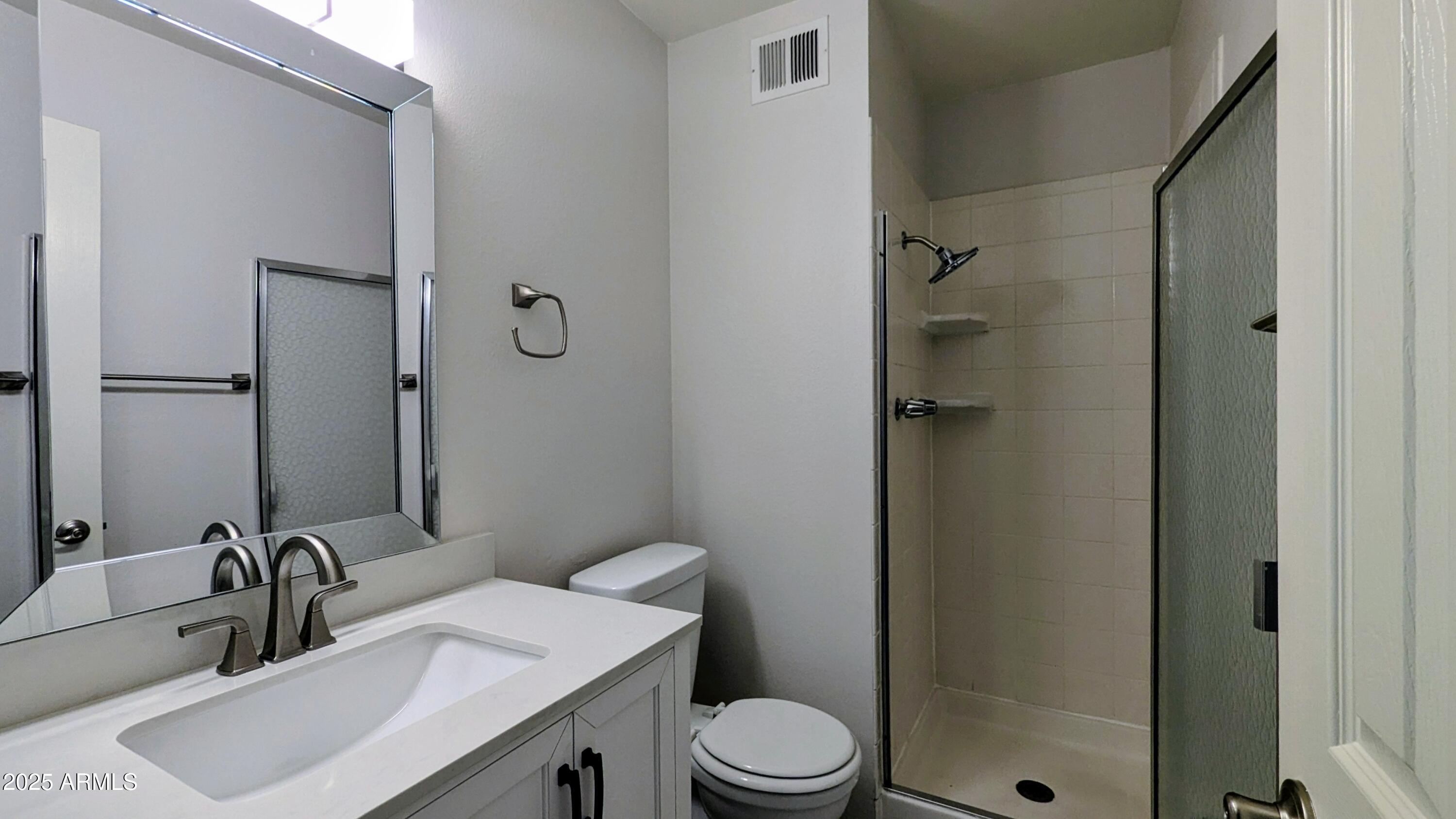 2228 East Campbell Avenue, Unit 234 Phoenix, AZ 85016 - Photo 16 of 18 a bathroom with a sink toilet and shower