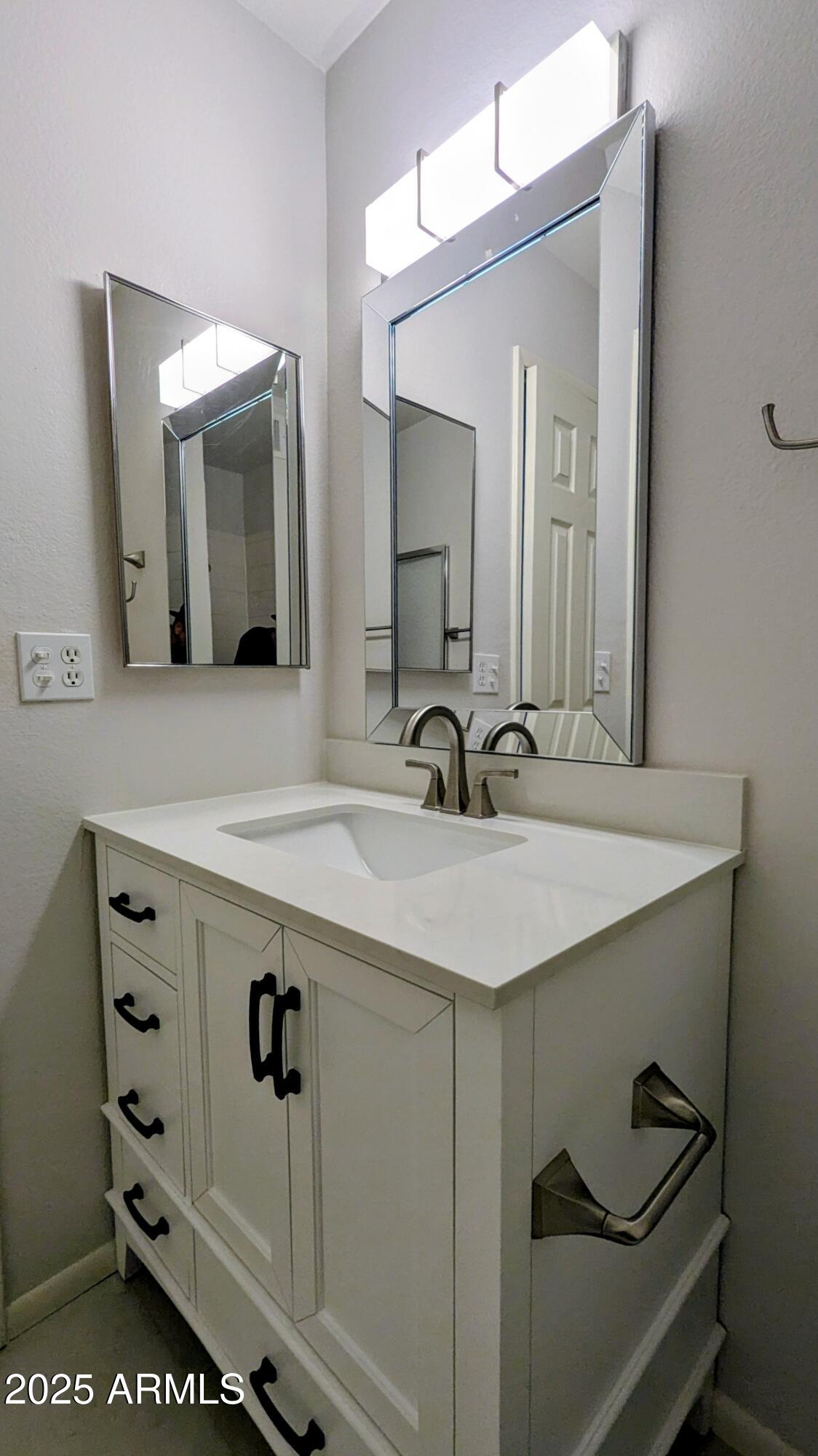 2228 East Campbell Avenue, Unit 234 Phoenix, AZ 85016 - Photo 17 of 18 a bathroom with a sink and a mirror
