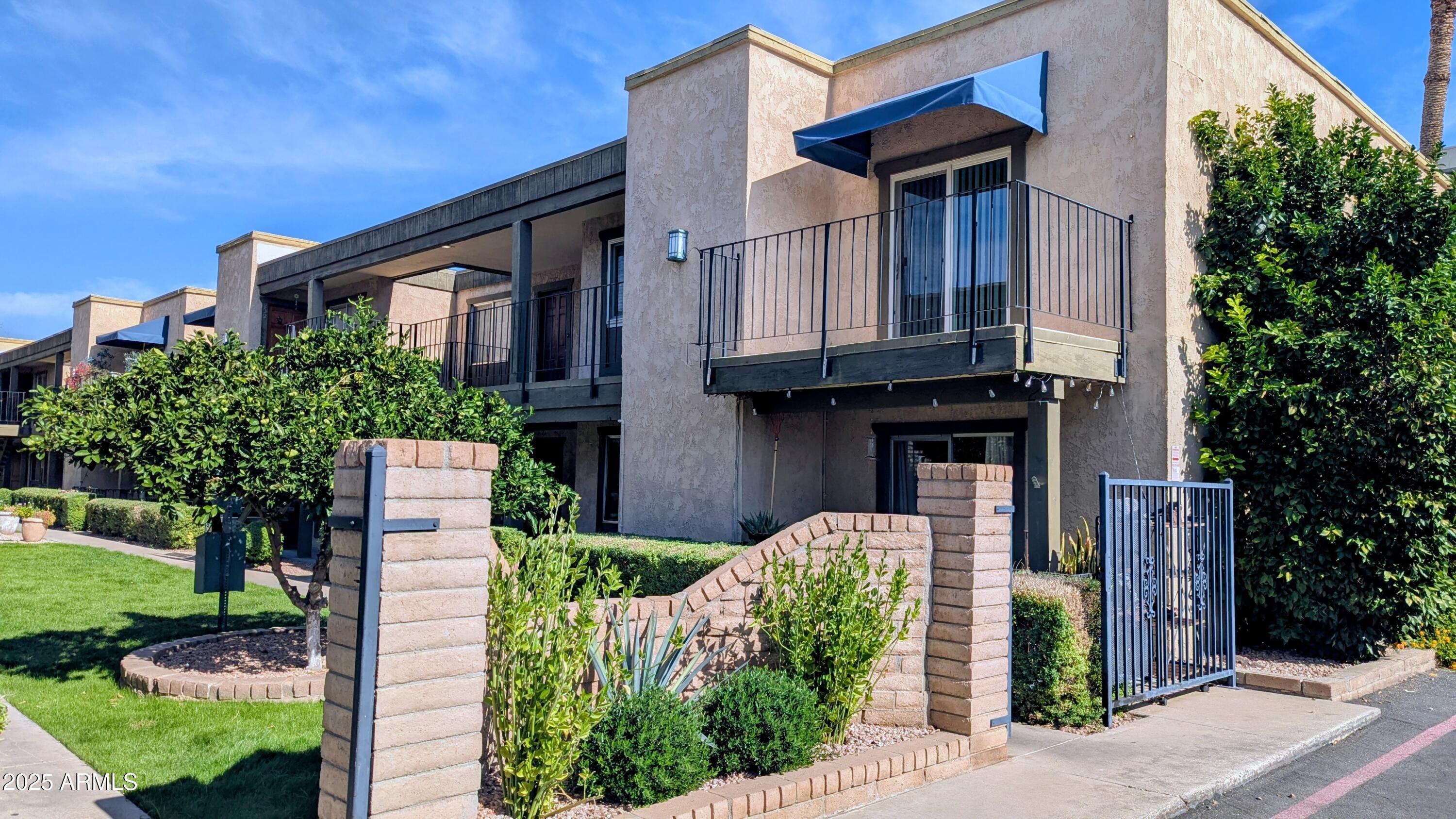 2228 East Campbell Avenue, Unit 234 Phoenix, AZ 85016 - Photo 4 of 18 a front view of a house with garden